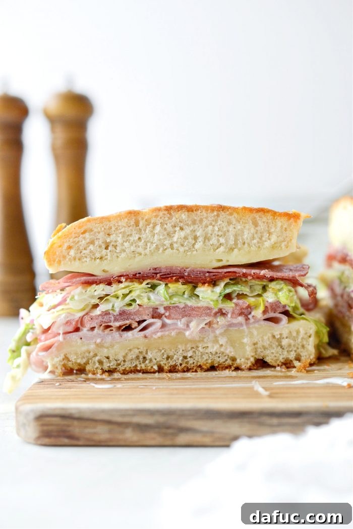 Old World Italian Sub 20 The Italian Grinder cut into four generous portions, revealing its delicious layers.