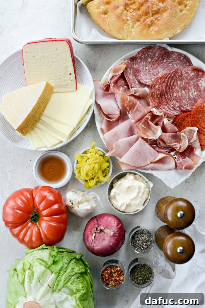 Old World Italian Sub 4 Array of fresh ingredients laid out for making the Italian Grinder, including deli meats, cheeses, and salad components.