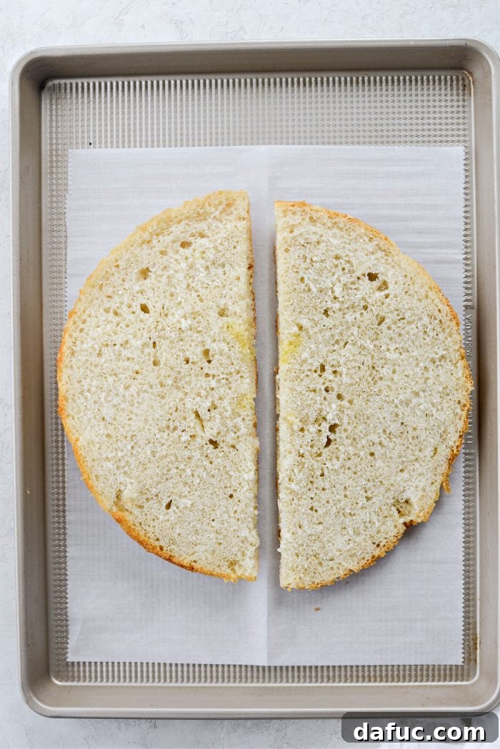Old World Italian Sub 5 Focaccia bread cut in half, showcasing its soft interior and airy texture, ready for toppings.