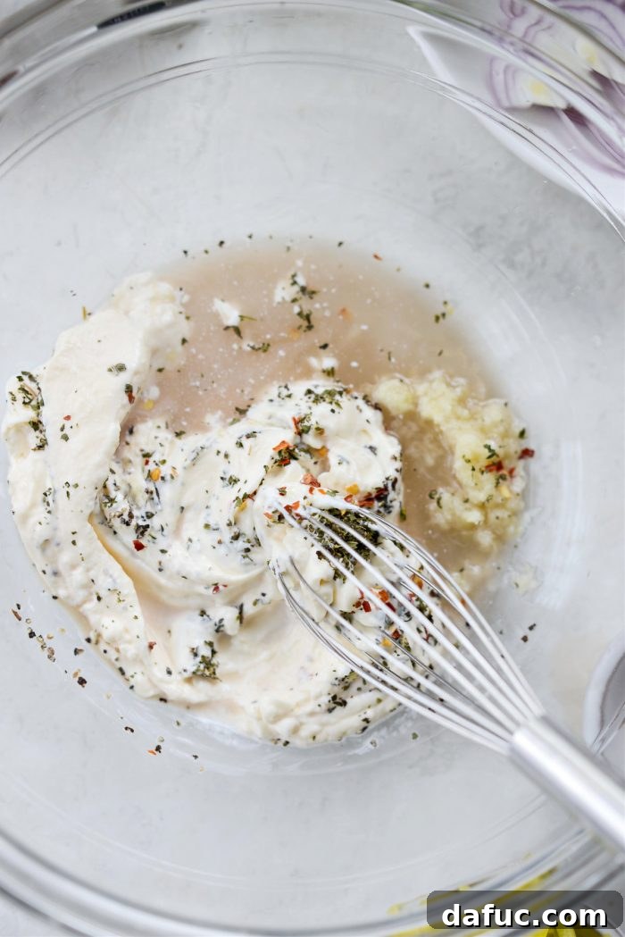 Old World Italian Sub 8 A hand whisking the grinder salad dressing ingredients together until smooth and creamy.