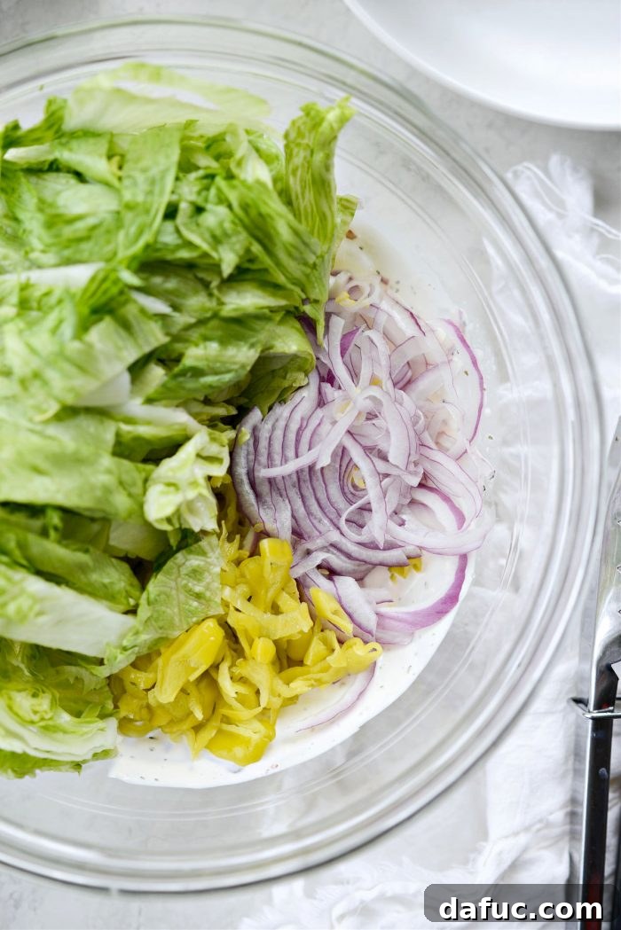 Old World Italian Sub 10 Sliced iceberg lettuce, peperoncini, and red onion added to the creamy grinder salad dressing.