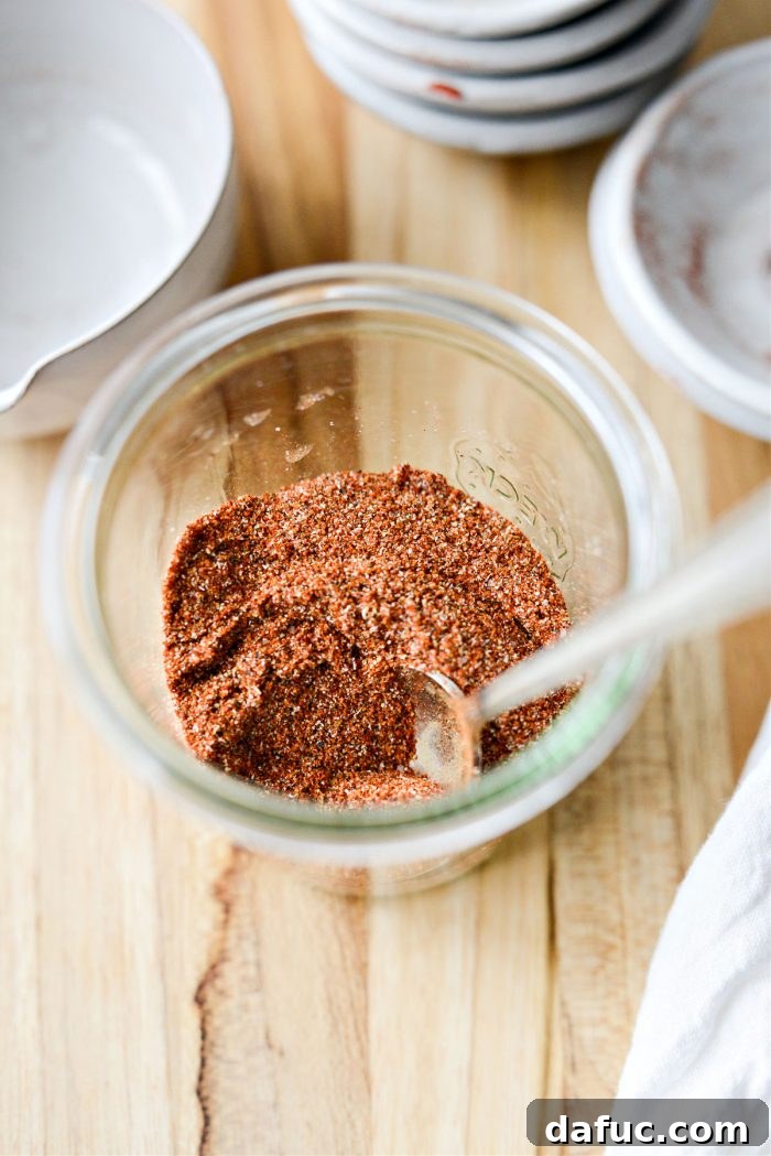 A beautifully composed shot of Street Taco Seasoning in a rustic jar, with a blurred backdrop suggesting a warm, inviting kitchen.