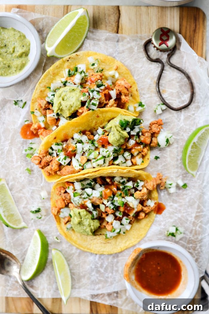 A close-up of a Chicken Street Taco with various toppings, showcasing its delicious layers