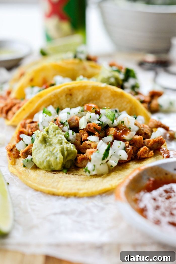 Chicken Street Tacos arranged beautifully on a serving board with cilantro and lime