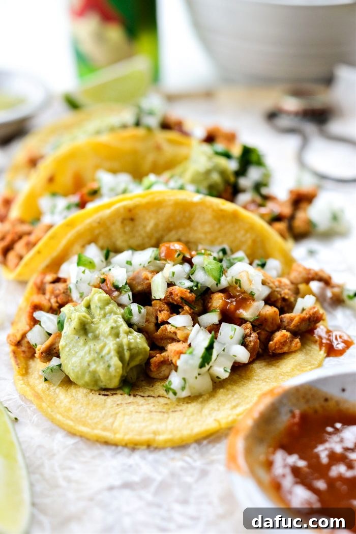Two Chicken Street Tacos with fresh toppings, ready to eat