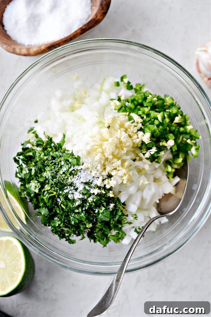 Freshly prepared onion salsa with diced white onion, jalapeño, garlic, and cilantro in a bowl