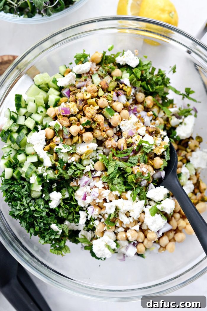 Tossing the Jennifer Aniston Salad ingredients in a bowl