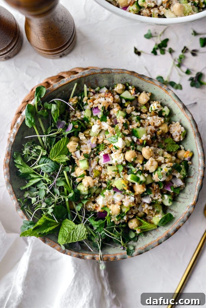 The Jennifer Aniston Salad served in a bowl, garnished with microgreens