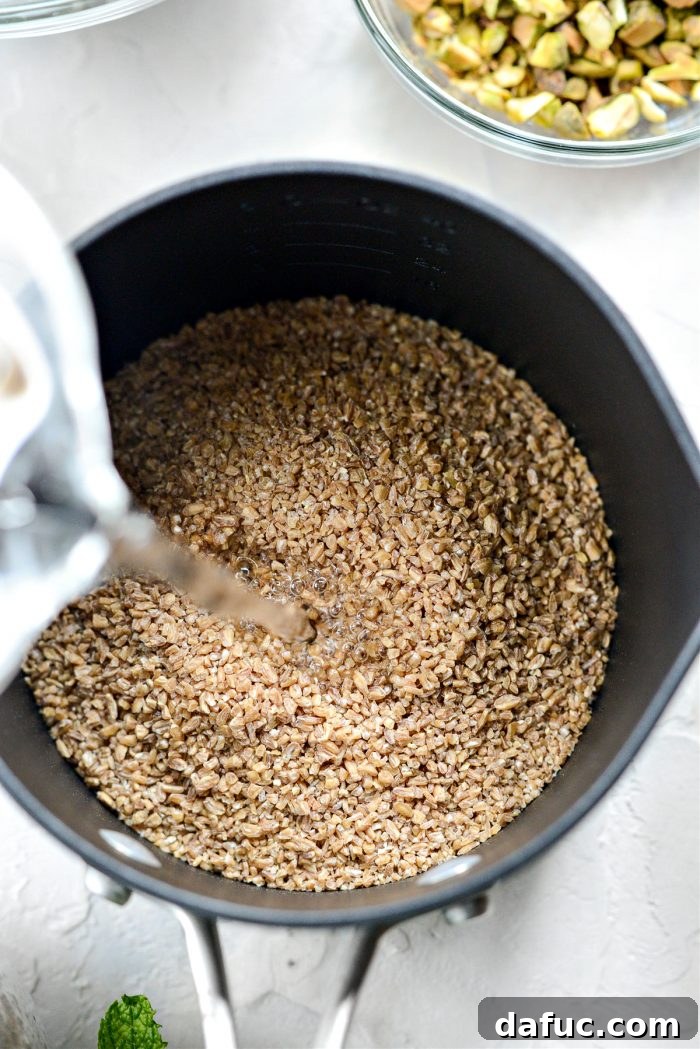 Bulgur wheat and water being added to a saucepan