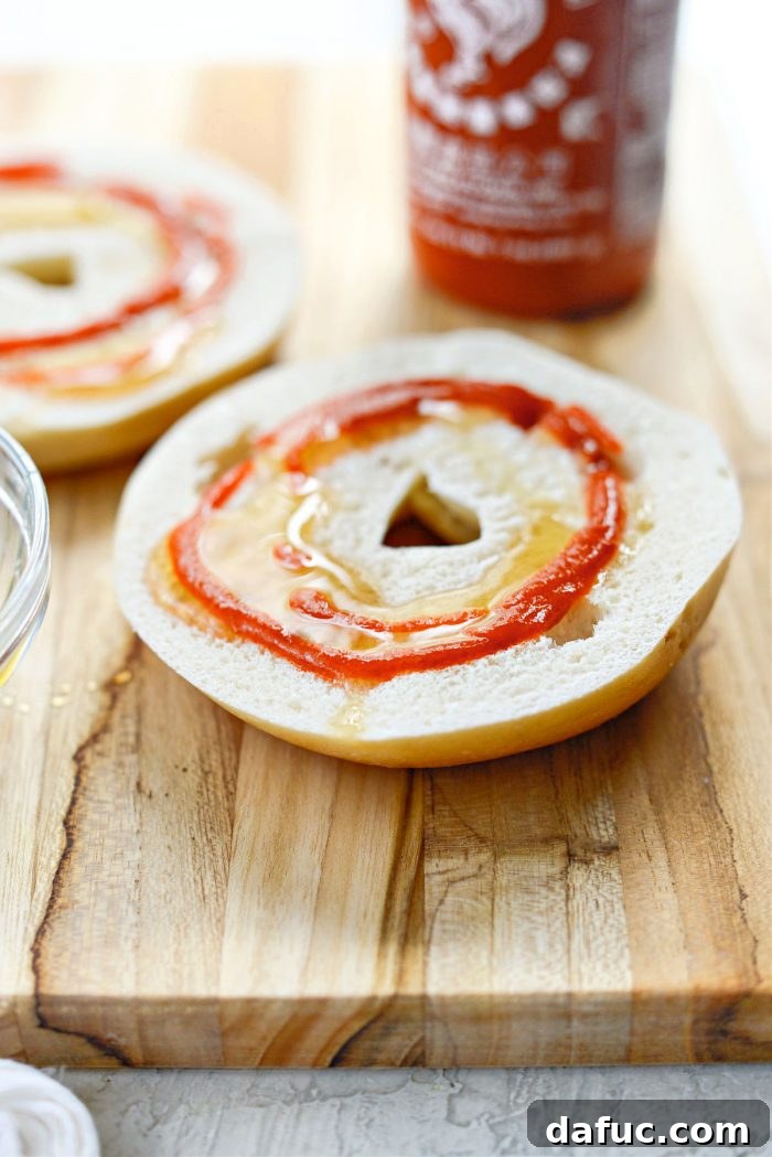Sweet & Spicy Bagel with Zesty Chive Cream Cheese 9 Bagel halves with sriracha drizzled on top of honey