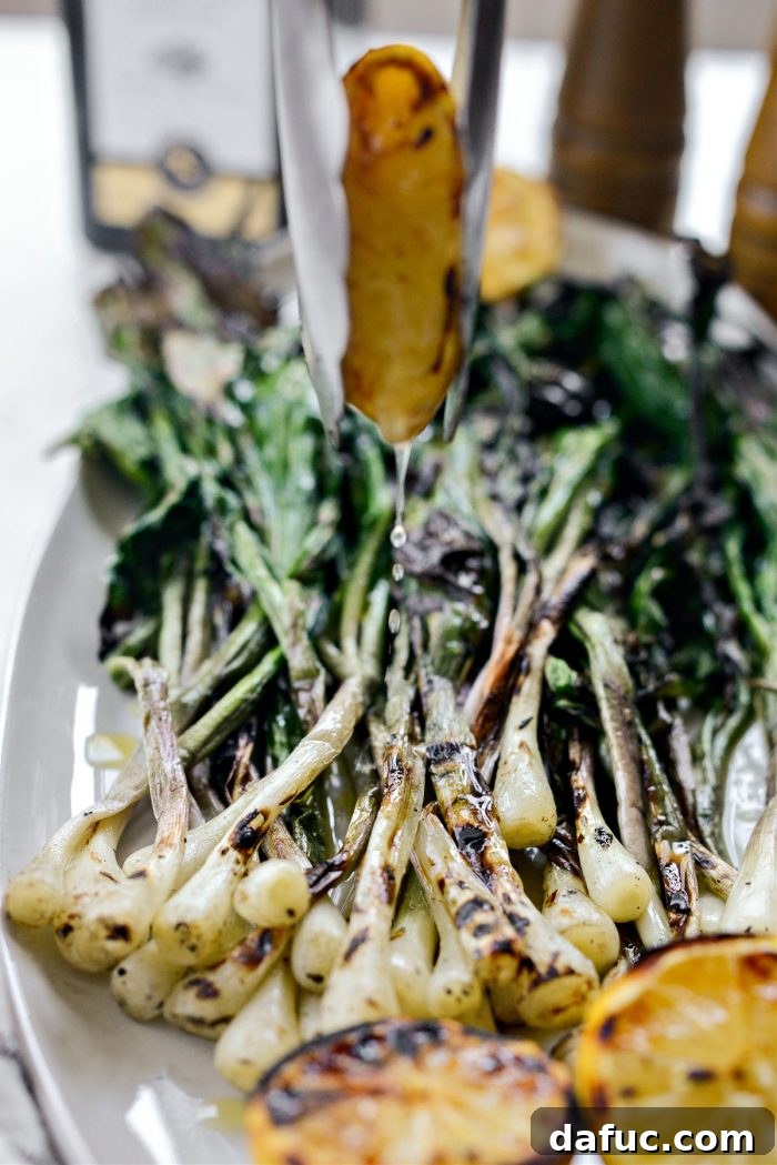 Charred Ramps Perfection 25 Juicy grilled lemon being squeezed over the dish