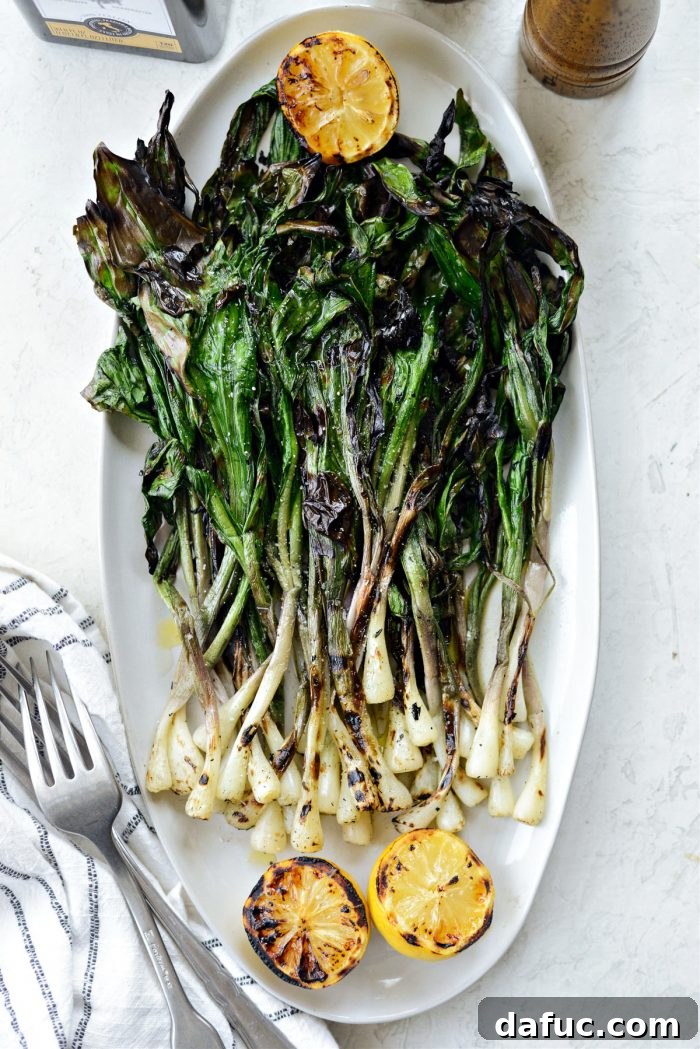 Charred Ramps Perfection 26 Platter of perfectly grilled ramps with charred lemons, ready to serve