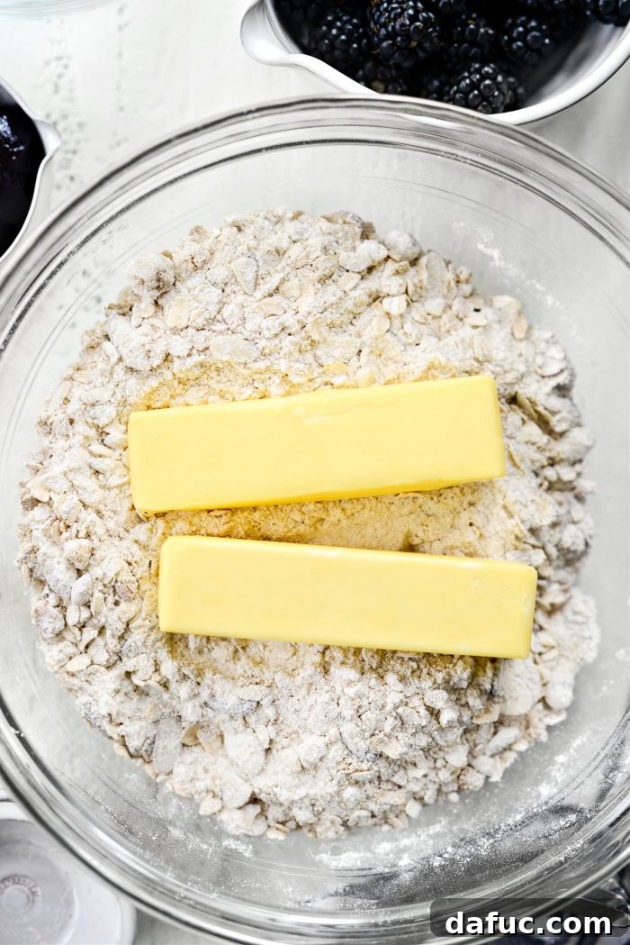 Blackberry Almond Crumble Bars 7 Adding cold unsalted butter to the dry streusel mixture