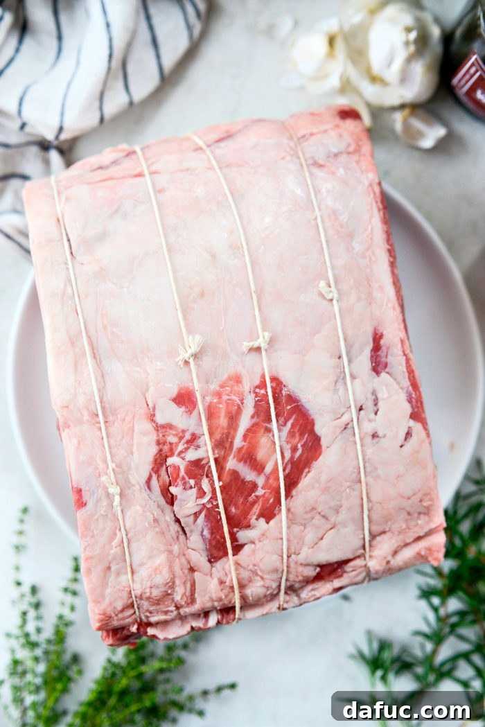 Rosemary Dijon Crusted Prime Rib with Pinot Noir Au Jus 12 Rib roast tied with kitchen string.