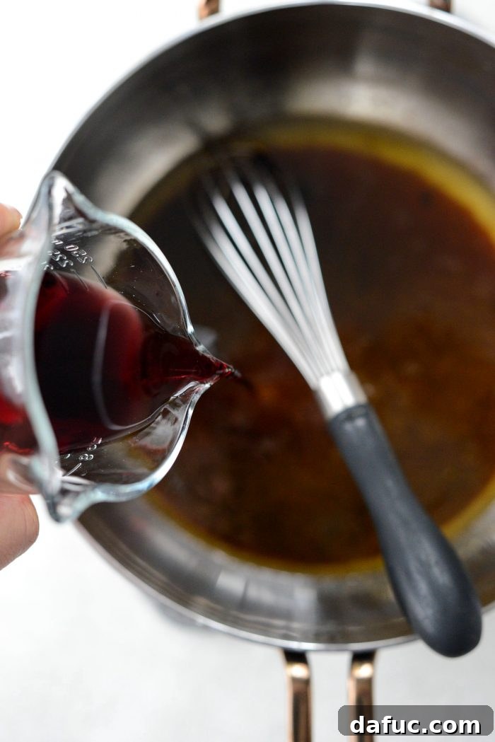 Rosemary Dijon Crusted Prime Rib with Pinot Noir Au Jus 22 Simmering pan drippings and pouring in Pinot Noir.