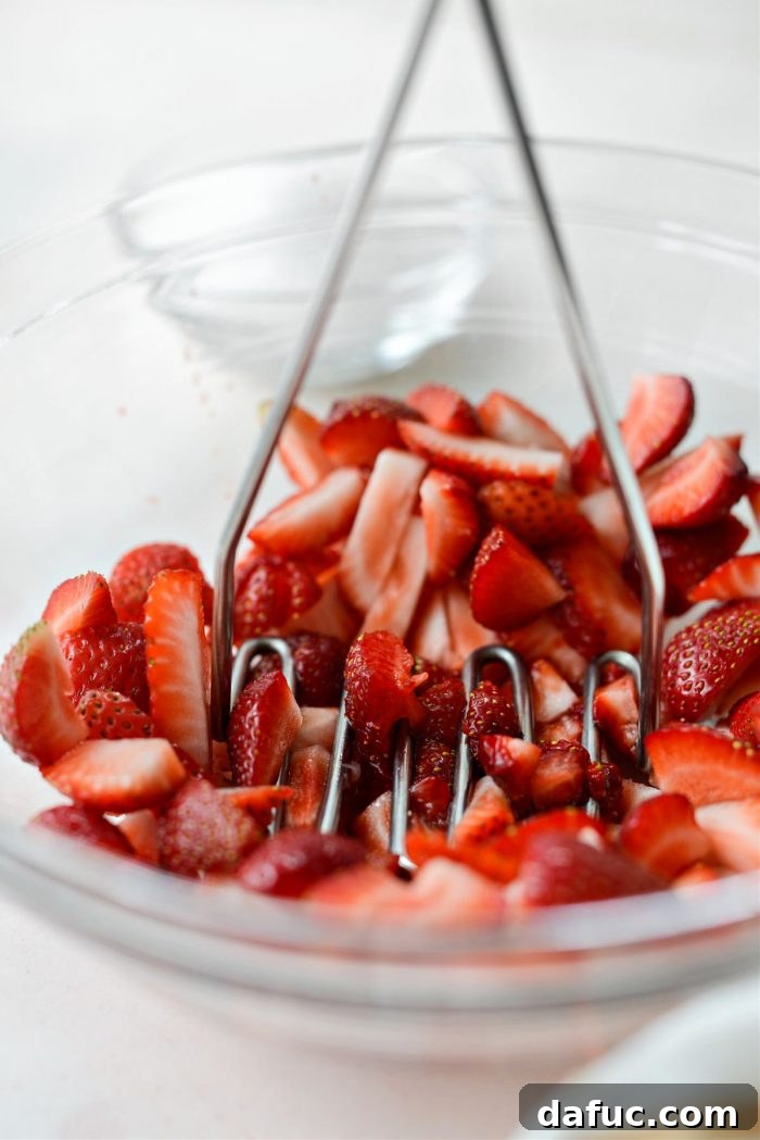 Freshly Baked Strawberry Dream 15 Mashing a portion of sliced strawberries