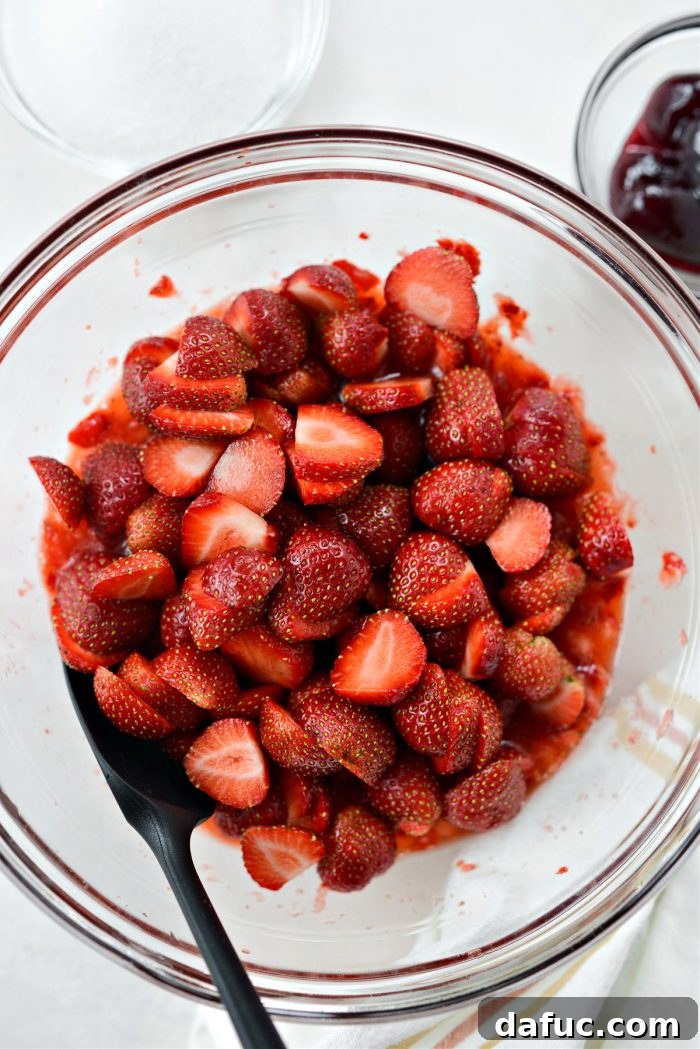 Freshly Baked Strawberry Dream 17 Adding remaining sliced strawberries to the bowl