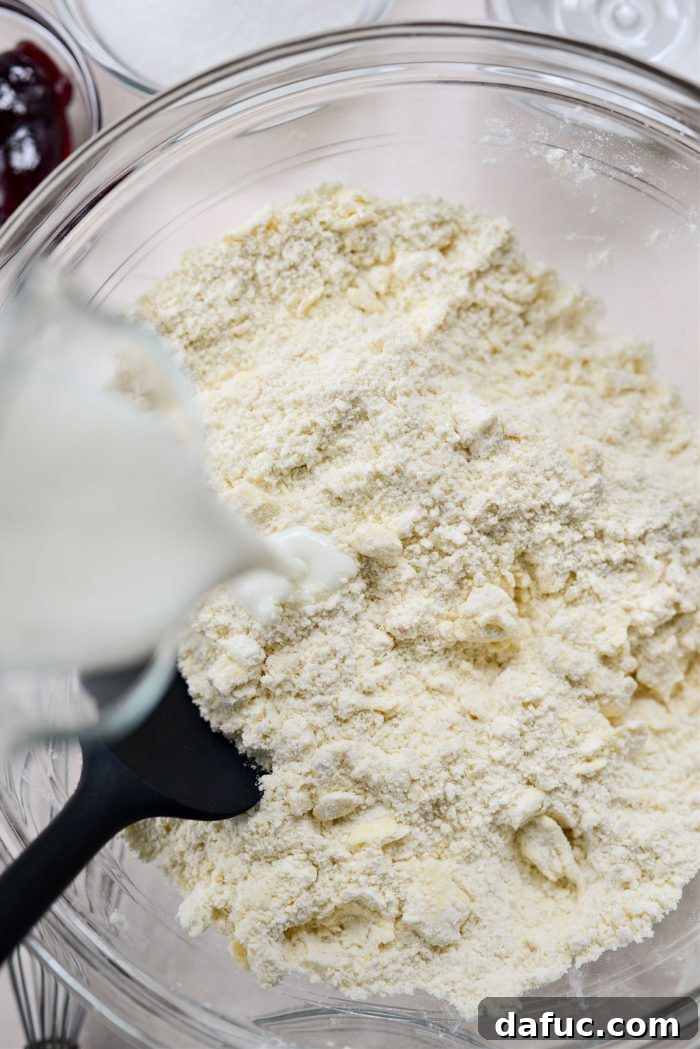 Freshly Baked Strawberry Dream 9 Adding buttermilk to biscuit dough