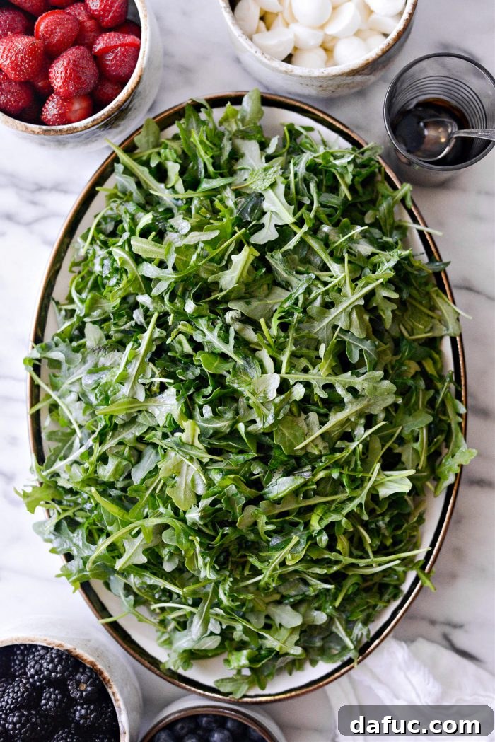 Sweet Berry Caprese Medley 9 arrange arugula onto a platter