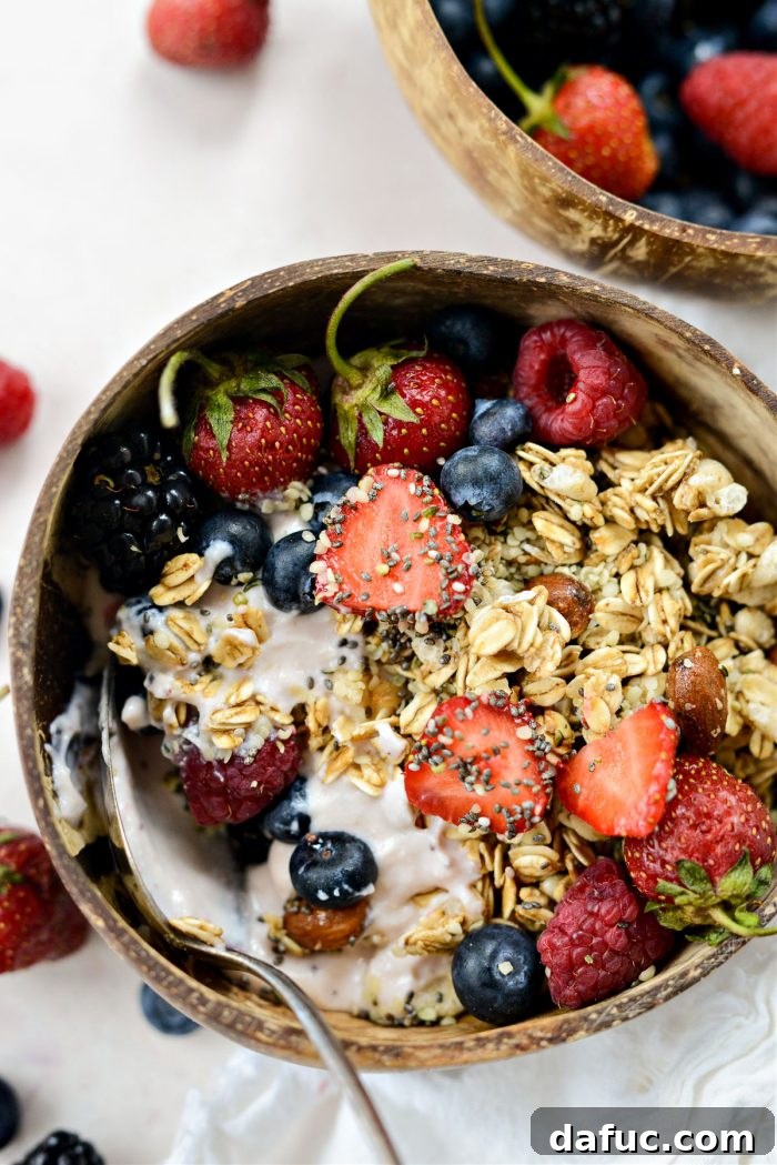 Decadent Strawberry Cheesecake Granola Bowl 13 Overhead shot of a vibrant Strawberry Cheesecake Granola Bowl with a spoon