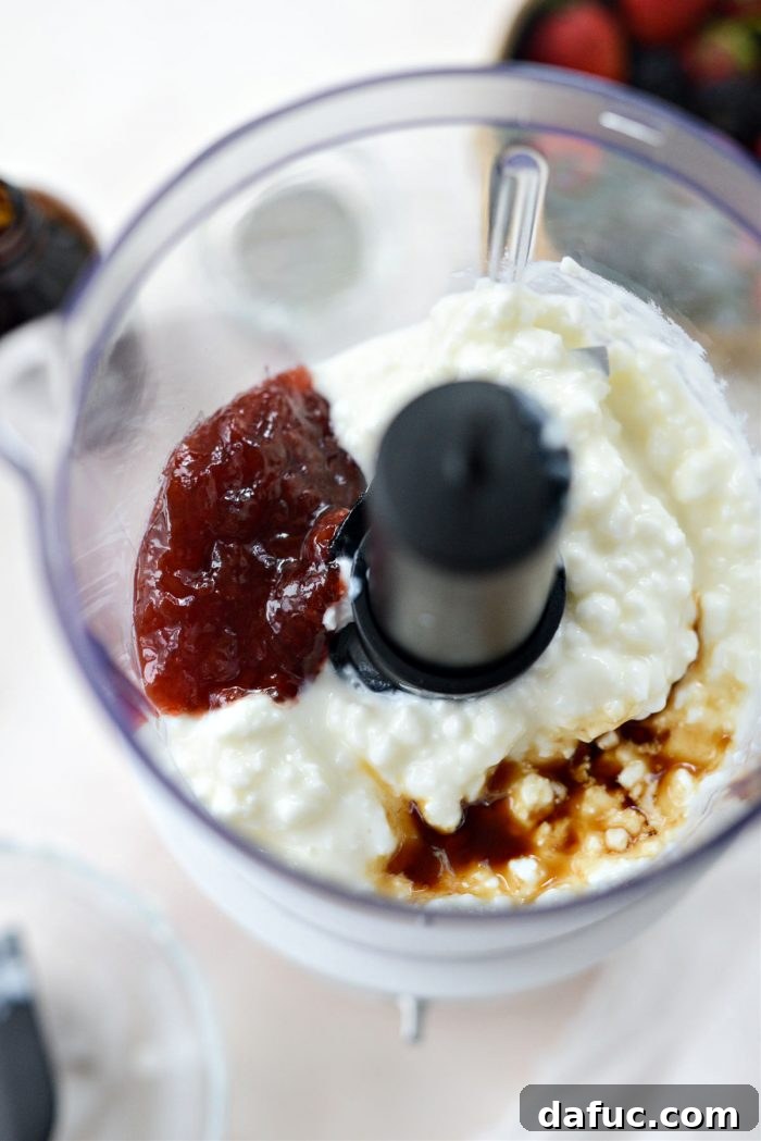 Decadent Strawberry Cheesecake Granola Bowl 5 Cottage cheese, strawberry jam, and vanilla extract in a mini food processor