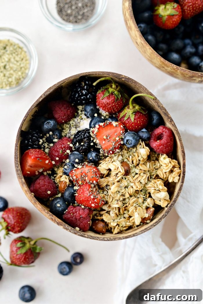 Decadent Strawberry Cheesecake Granola Bowl 10 Garnish with fresh berries, chia seeds, and hemp seeds