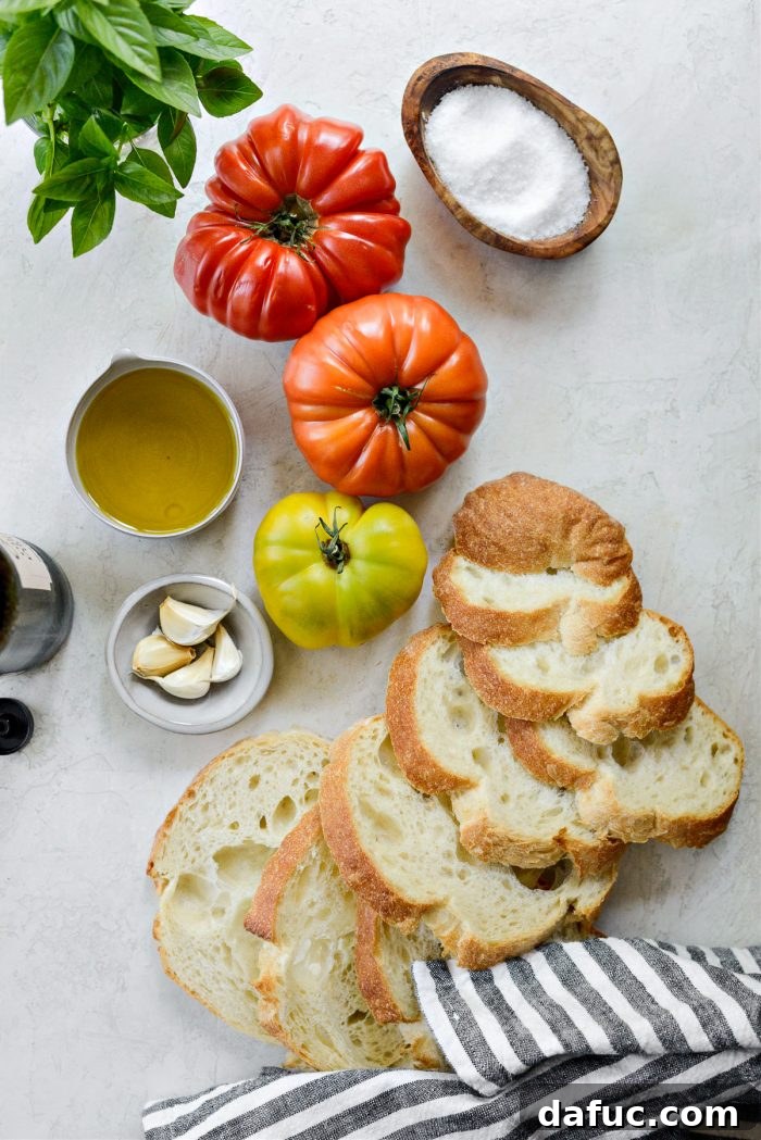 Vibrant Heirloom Tomato Bruschetta 4 The essential ingredients for Heirloom Tomato Bruschetta laid out: fresh heirloom tomatoes, a bunch of basil, garlic cloves, and a bottle of olive oil.