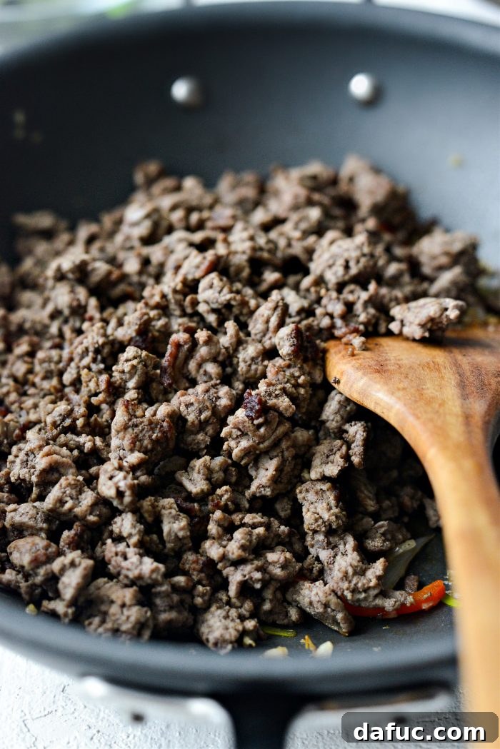 Browned beef returned to the pan with stir-fried vegetables