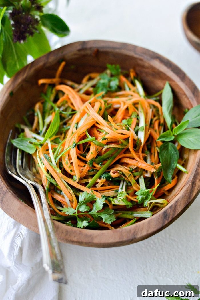 Vibrant Thai Carrot Slaw 10 Thai Carrot Slaw with a serving spoon, close up.