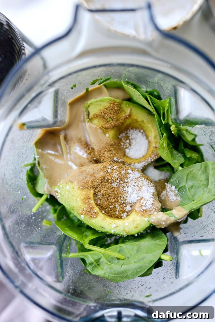 Vibrant Green Goddess Hummus 9 Adding spinach, avocado, tahini, and spices to the blender