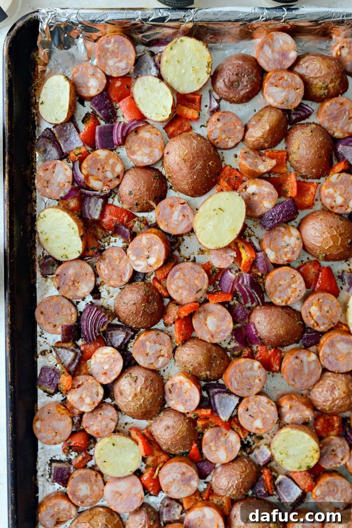 Add sliced andouille sausage to the sheet pan