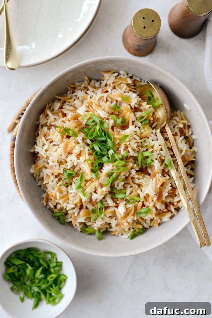 Fluffing homemade rice pilaf with a fork after cooking and resting