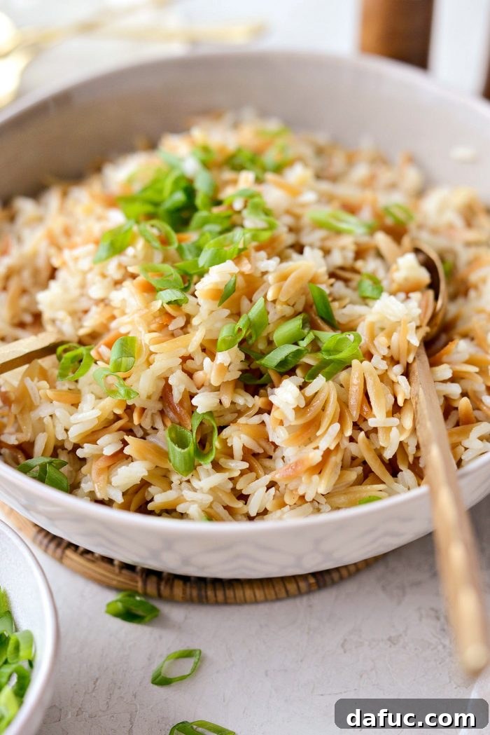 Beautifully garnished rice pilaf with fresh green onions, ready to be served as a delicious side