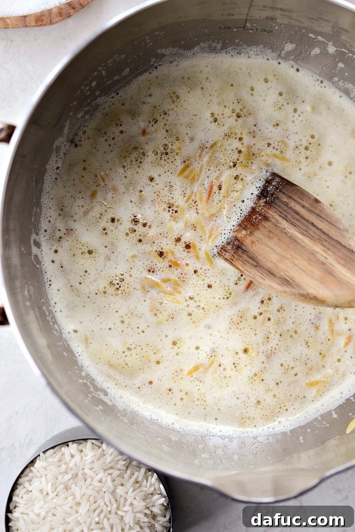 Stirring orzo pasta to coat evenly in melted butter for rice pilaf