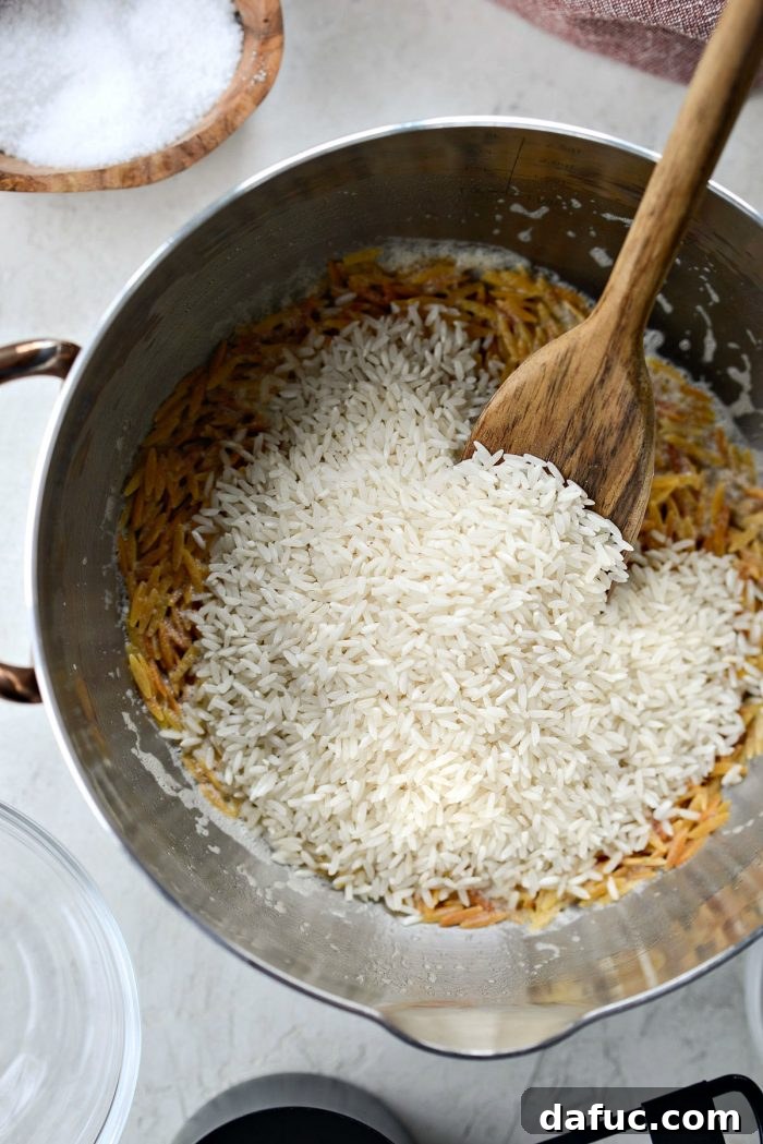 Orzo pasta toasting to a golden brown in butter, stirred regularly to prevent burning