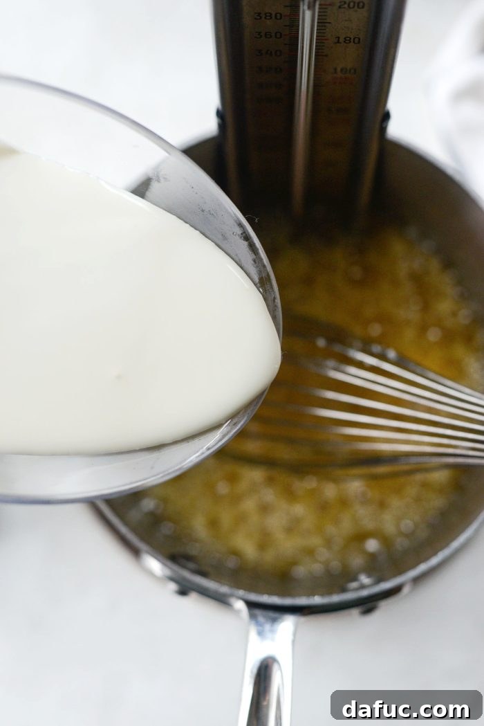 Sweet & Simple Homemade Caramel Apples 14 carefully pouring in heavy cream while stirring