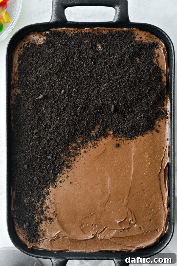 Decadent Chocolate Garden Delight 25 Sprinkling crushed Oreo cookie crumbs liberally over the frosted cake