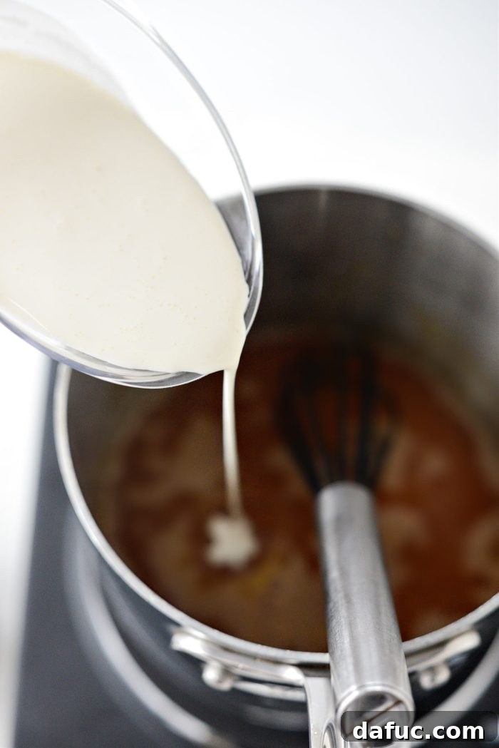 Pouring heavy cream into the caramel while whisking