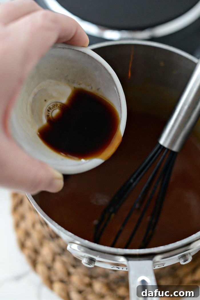 Adding vanilla extract to the caramel sauce