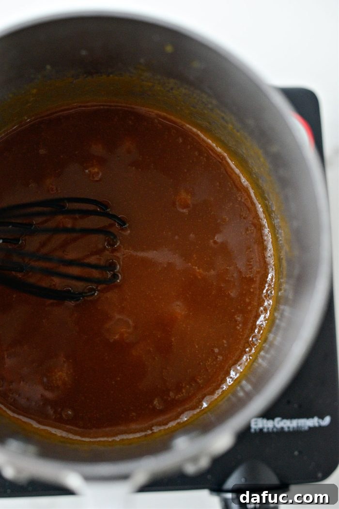 Stirring caramel sauce until smooth and combined