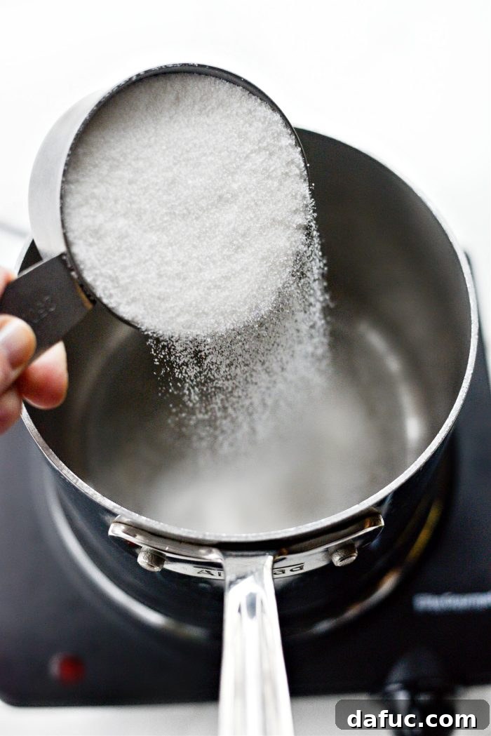 Adding granulated sugar to a stainless steel pot