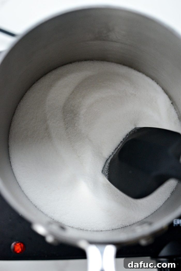 Heating sugar over medium-high heat, stirring occasionally