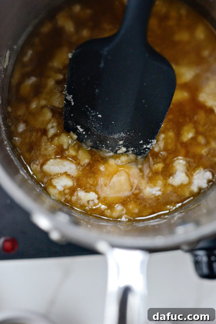 Continuing to stir as the sugar's color deepens to golden