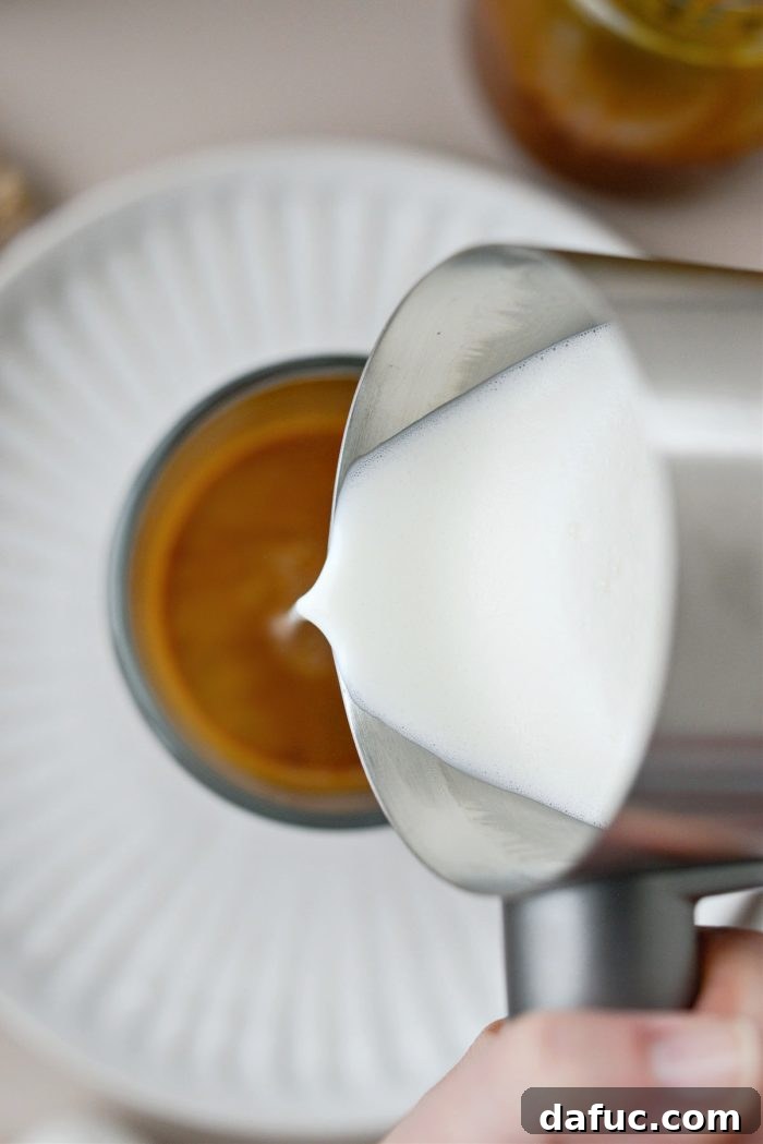 Caramel Brulee Latte 9 Pouring frothed milk into the mug