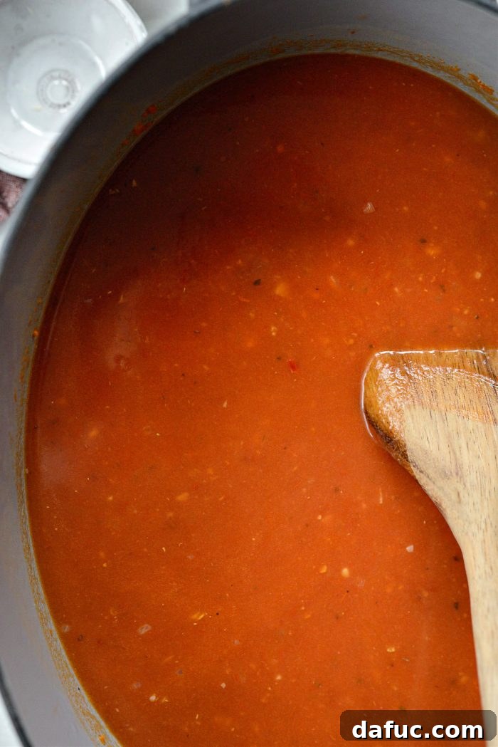 Bringing the soup to a low boil.
