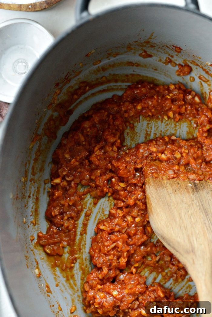 Stirring the vodka and tomato mixture.