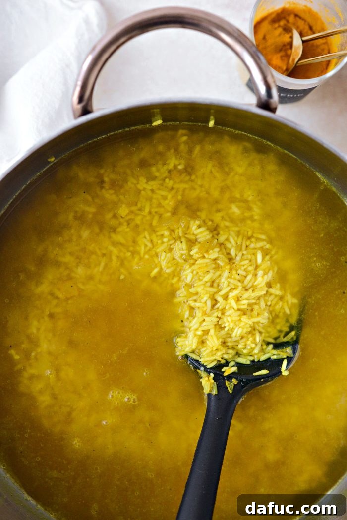 Golden Turmeric Rice 13 Stirring the rice and broth mixture