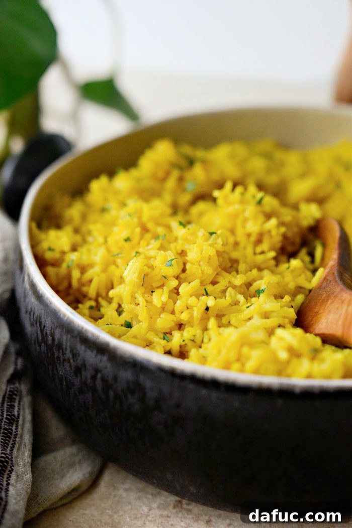 Golden Turmeric Rice 3 Close-up of fluffy Turmeric Rice in a pan