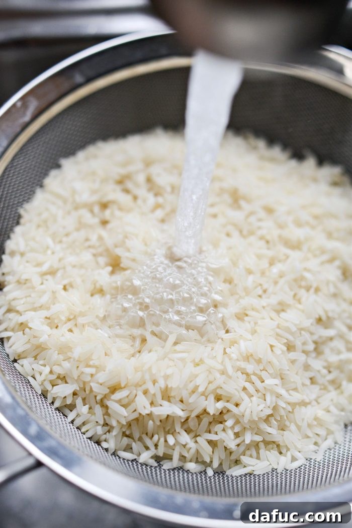 Golden Turmeric Rice 7 Rinsing basmati rice under running water until clear