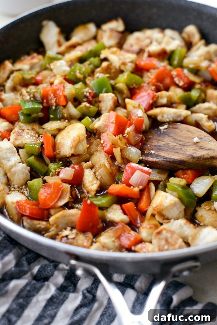 Guilt-Free Sesame Chicken 16 Pouring Sesame Sauce over Chicken Stir-fry